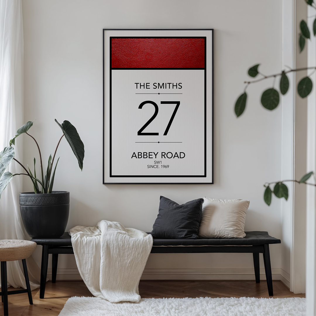 Framed poster of 'The Smiths 27 Abbey Road' on a wall above a bench with cushions.