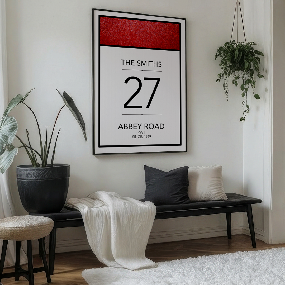 Living room with a framed picture of The Smiths' Abbey Road album cover, a bench, and plants.