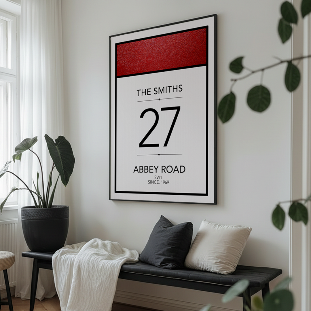 Framed poster of 'The Smiths 27 Abbey Road' on a wall above a bench with cushions.