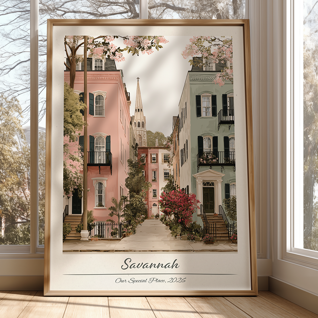 Framed artwork of a street scene in Savannah with cherry blossoms, displayed in a room with large windows.
