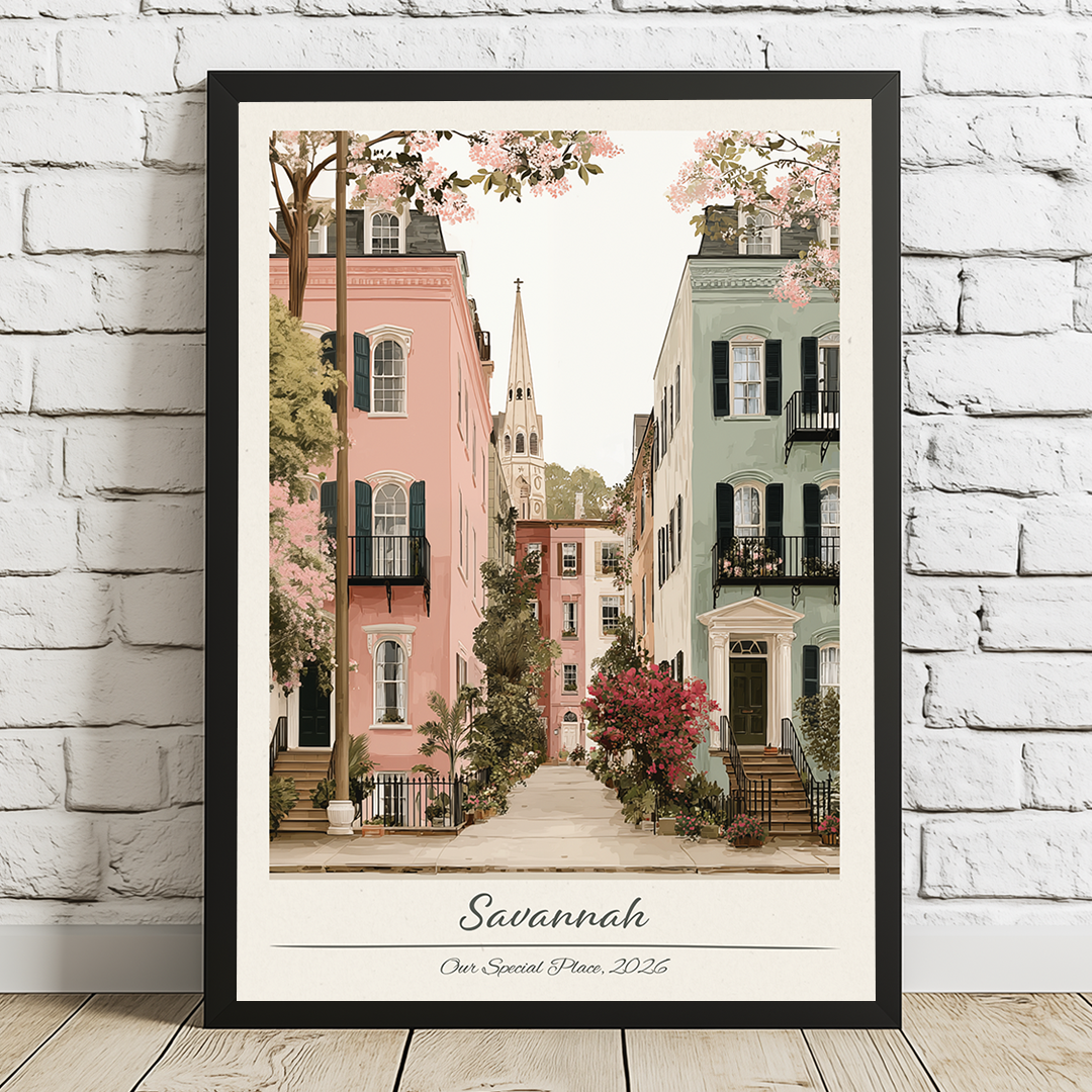 Framed artwork of a street scene in Savannah with colorful buildings and cherry blossoms.