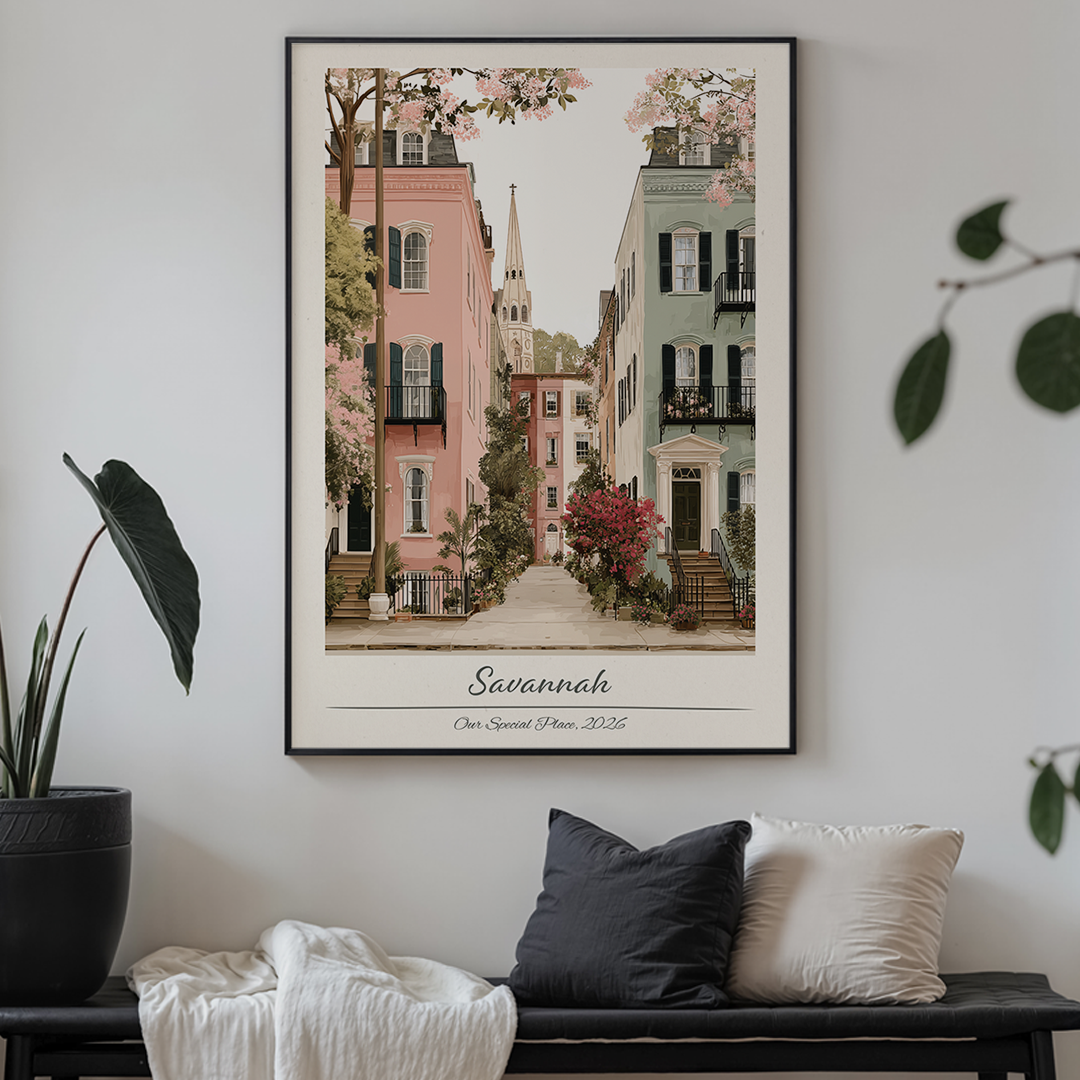 Framed artwork of a street scene in Savannah on a wall above a bench with cushions.